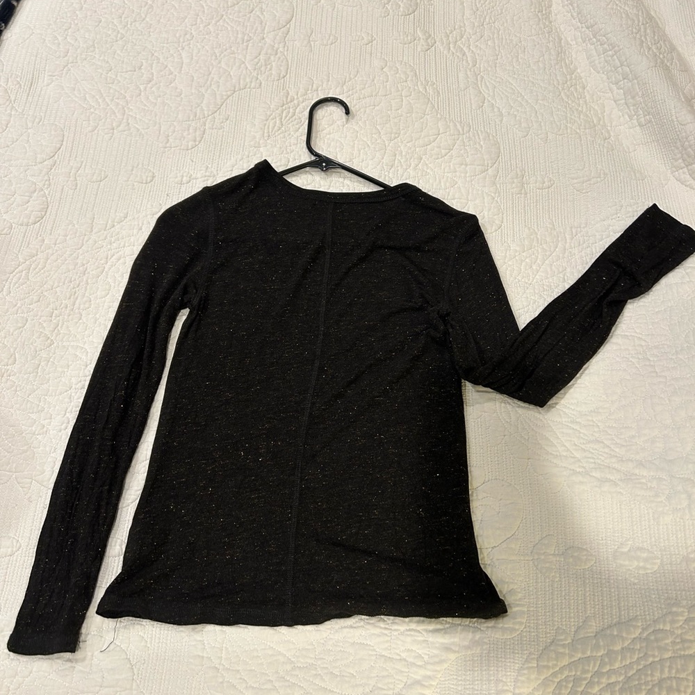 Black long sleeve with gold flecks.